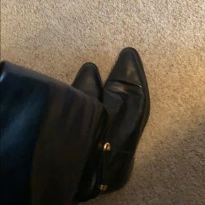 Tall black leather boots , knee length